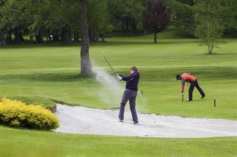 Golf Clubs Tending The Flag