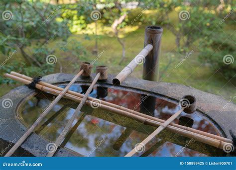 Japanese Basin Called Tsukubai With Ladles For Water In A Ritual Hand