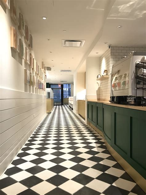 Freshii Restaurant Green Wall Paneling Black And White Floor