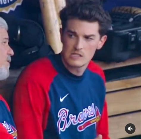 Two Baseball Players Sitting Next To Each Other