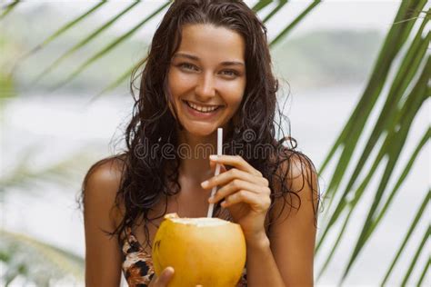 Beach Babe Tanned Bikini Clad Woman Enjoying Fresh Coconut Water On Sandy Shore Stock Photo
