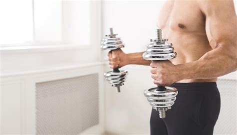 Premium Photo Unrecognizable Muscular Naked Man Holding Big Dumbbells In Hands Panorama Copy