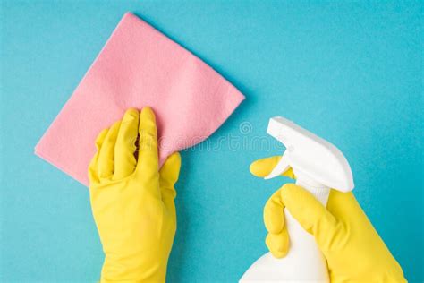 Top View Photo Of Hands In Yellow Rubber Gloves Holding Pink Viscose