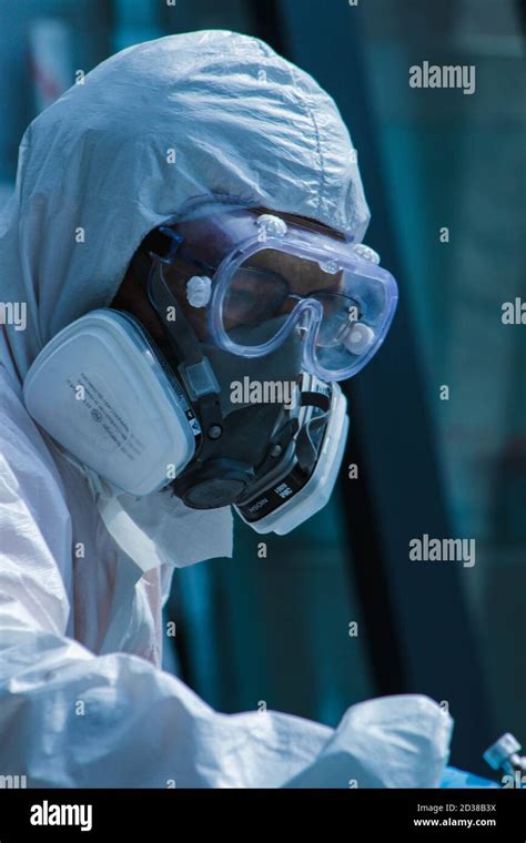 Vertical Shot Of A Person In A Hazmat Suit Stock Photo Alamy