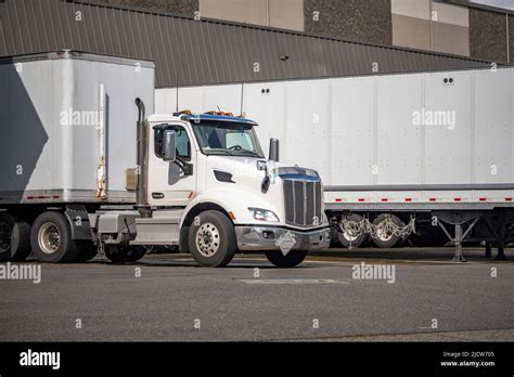 Big Rig Day Cab White Semi Truck With Dry Van Semi Trailer In Row With