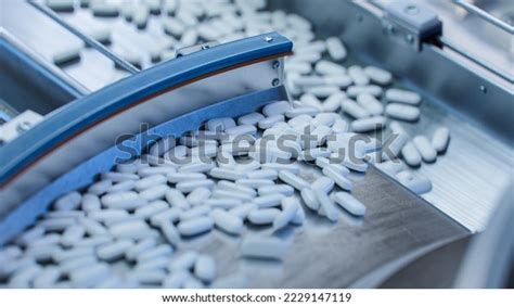 tablets capsules manufacturing process close  shot stock photo