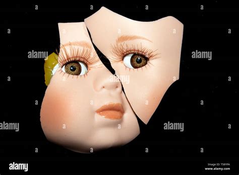 Broken Doll Body Parts Faces On Black Background Stock Photo Alamy