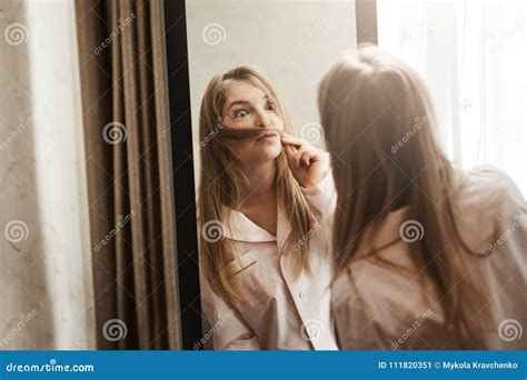 Fooling Around While Nobody See Portrait Of Adorable Playful Blonde Woman Making Moustache From