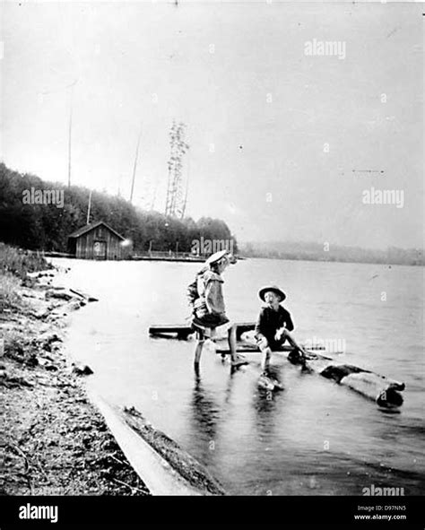 Two Children Playing In Green Lake Stock Photo Alamy