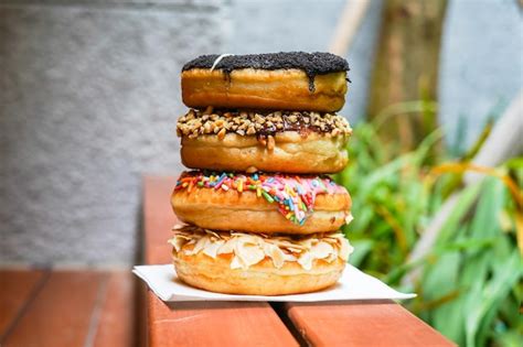 Una Pila De Donas En Una Mesa Con Un Fondo Verde Foto Premium