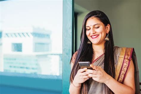 Premium Photo Beautiful Indian Woman In A Saree Using Her Mobile Phone