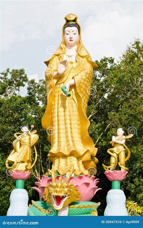 Golden Statue Of Guan Yin With Children In Temple At Phan Nga T Stock