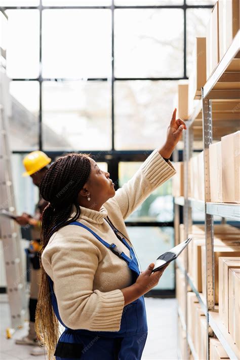 Premium Photo | Warehouse worker reaching for parcel at cardboard boxes