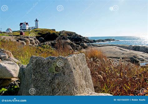 Lighthouse In The Distance On Rocky Shore Stock Image Image Of Autumn