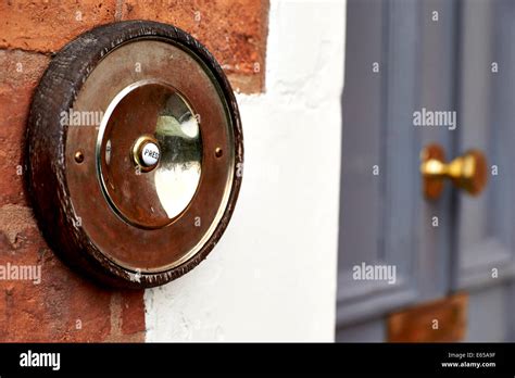 An Old Fashioned Doorbell Pictured Next To A House Front Door Stock