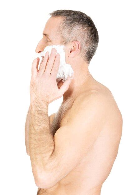 Premium Photo Shirtless Mature Man Applying Shaving Cream On His Face Against White Background