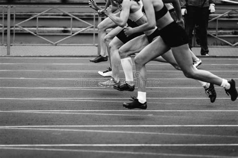 Women Sprinters At Starting Position Ready For Race On Racetrack Stock