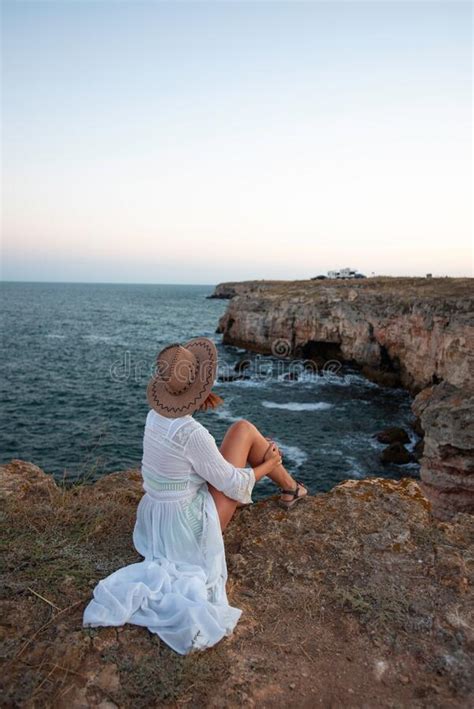 Fille Rousse Dans Une Robe Blanche Reposant Sur Une Falaise Sur La Mer