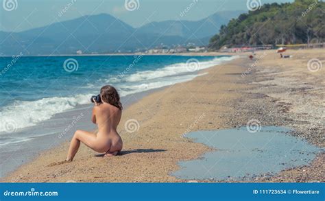 Beautiful Female Photographer With Professional Camera On The Beach Background Naked Woman In