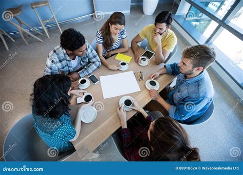 Creative Business Team Having Meeting Over Coffee In Meeting Room Stock