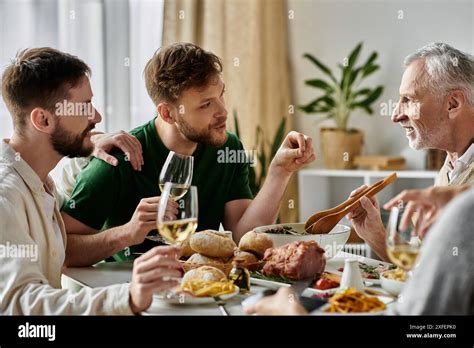 A Gay Couple Enjoys A Meal With Parents At Home Sharing A Toast Stock Photo Alamy