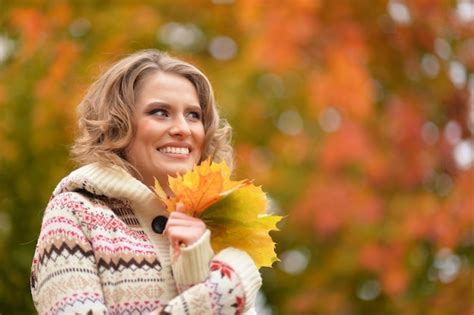 Premium Photo Portrait Of Beautiful Young Woman Holding Autumn Leaves