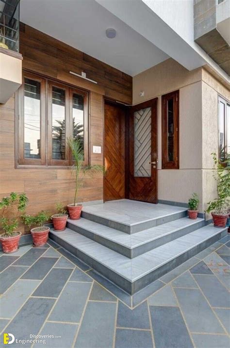 The Front Entrance Of A House With Potted Plants And Steps Leading Up To It