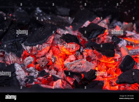 Barbecue Grill Pit With Glowing And Flaming Hot Charcoal Briquettes