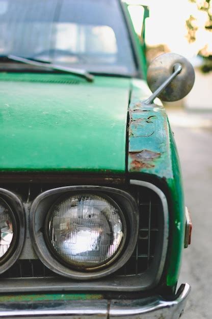 Premium Photo Cropped Image Of Damaged Green Vintage Car Parked On Road