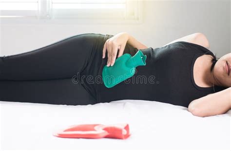 Woman Using Hot Water Bag Or Bottle On Her Stomach Ache Sleep Stock Photo Image Of Care Lying