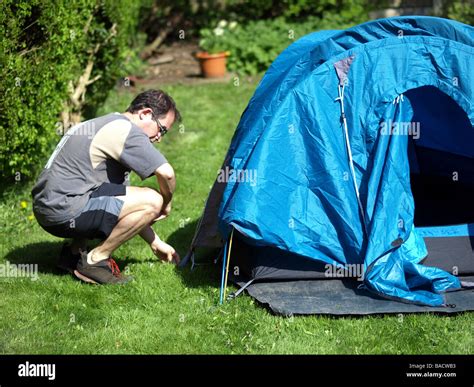 A camper setting up his tent Stock Photo - Alamy