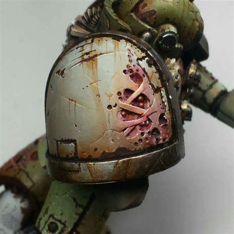 a close up of a warhammer with paint on it's face and helmet