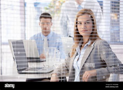 Attractive Businesswoman Behind Blind Smiling Stock Photo Alamy