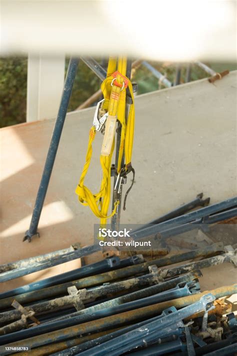 Bunch Of Safety Harnesses Hanging Together On Scaffolding On A