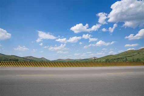 Asphalt Highway Landscape Under Blue Sky And White Clouds Stock Image