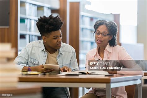 Volunteer Tutor Helps High School Student High Res Stock Photo Getty