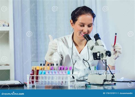 Lab Technician Assistant Analyzing A Blood Sample In Test Tube At