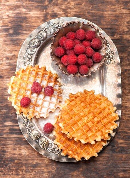 Premium Photo Belgian Waffles With Raspberries And Sugar Powder On