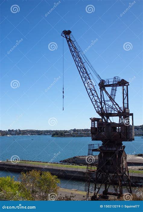 Industrial Crane Set Dockside On Cockatoo Island Sydney Harbour Australia Against Blue Water And