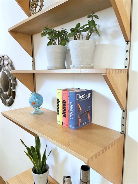 String Modular Wall Shelf With Two Steel Side Elements And Three Walnut