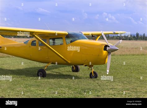 Small And Light Yellow Piper Aircraft Near To The Runaway Ready To Take