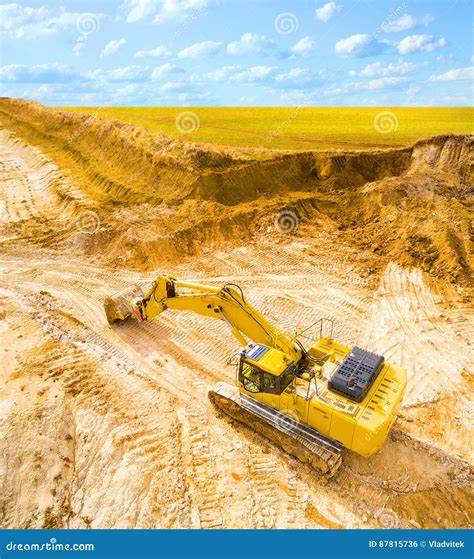 Working Excavator On Site Loading Dumper Truck During Earthmoving