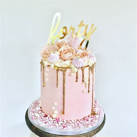 Pink Buttercream Cake With Buttercream Flowers Including Roses And Peonies A Gold Drip And