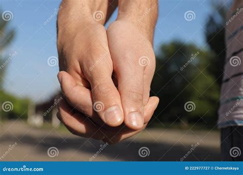 Gay Couple Holding Hands Together In Park On Sunny Day Stock Image