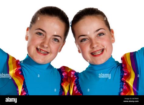 Studio shot of beautiful young identical twins in colourful Mexican ...