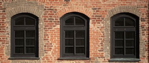 Premium Photo Brick Wall Of An Old Building With Arched Windows