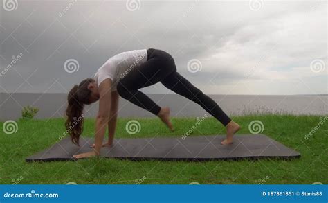 Young Fit Woman Practice Yoga On Coast Near The Lake Or Sea Woman