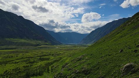 Mountainous landscape with fields and clouds 38595648 Stock Video at Vecteezy