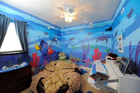 A Bedroom Decorated In Blue And Orange With An Ocean Theme On The Wall