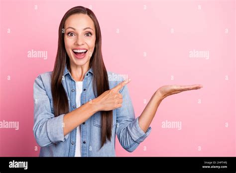 Photo Of Hooray Brown Hairdo Mature Lady Indicate Hold Promo Wear Jeans Shirt Isolated Over Pink